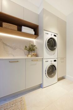 a washer and dryer in a white laundry room