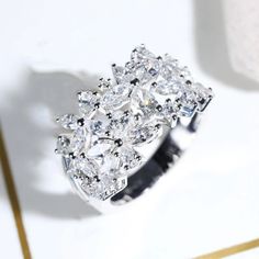 a diamond ring sitting on top of a table