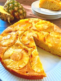 a pineapple upside down cake on a plate with one slice cut out from it