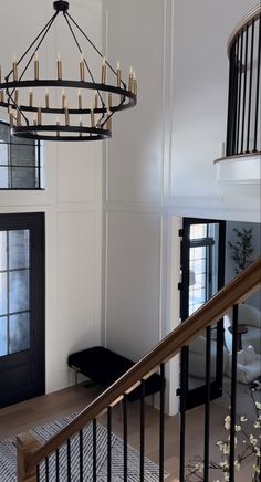 a chandelier hanging from the ceiling in a living room next to a door