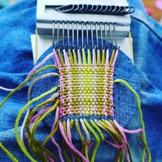 a close up of a piece of cloth with some scissors on it and thread in the middle