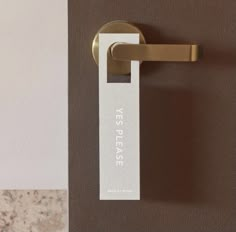 a close up of a door handle with a name tag attached to the side of it