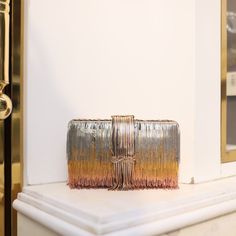 Money back guarantee, if this clutch doesn’t make you dance the shimmy! Seriously! Made of multiple rows of metallic fringe tassels that are crafted by hand to achieve the luxuriously shimmering gradient effect, this labor of love has captured so many hearts since she was launched and is our best selling clutch since 2019! Add her to your cart, you won’t regret it! Composition: Ombre pattern of silver, gold and rose gold metal hanging chains; top flap has the chains braided Lush black velvet int Modern Party Clutch With Gold-tone Hardware, Rectangular Party Clutch With Gold-tone Hardware, Gold Hand-embellished Clutch For Evening, Luxury Gold Clutch With Gold-tone Hardware, Luxury Gold Hand-embellished Clutch, Chain Braid, Ombre Pattern, Party Clutch, Braid Designs