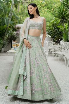 Pistachio green lehenga with bead embellishment in floral motifs and cutwork detail on the waistband. Comes with sleeveless blouse and dupatta.
Components:3
Pattern:Embellishment
Type of Work:Bugle Beads, Cutdana and Sequin
Neckline:Sweetheart
Sleeve Length:Sleeveless
Fabric:Silk Organza
Color:Green
Other Details:
Blouse with cutwork detail
Dupatta with embroidered border
Tie up on the side
Occasion:Wedding - Aza Fashions Varun Chakkilam, Embroidered Bridal Lehenga, Green Lehenga, Bugle Beads, Silk Organza, Designer Gowns, Green Silk, Cut Work, Bridal Lehenga