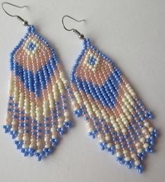 These fringe style earrings are handmade by me, Janet J. Griffen...  They are made with #11 glass seed beads...  The colors are blue, pink, white and glass seed beads and beaded with Nymo thread... Measurements of the earrings are 2 3/4 inches long by 1 inch wide and the ear hooks are of gold tone... Any questions, please e-mail me.... Handmade Southwestern Blue Beaded Earrings, Blue Southwestern Beaded Fringe Earrings, Southwestern Blue Beaded Fringe Earrings, Blue Hand-strung Dangle Beaded Earrings, Blue Hand-strung Round Beads Earrings, Blue Hand-strung Bohemian Earrings, Bohemian Blue Hand-strung Earrings, Southwestern Handwoven Blue Jewelry, Fringe Fashion