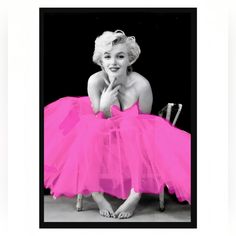 a black and white photo of a woman in a pink tutu skirt with her legs crossed