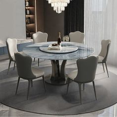 a dining table with chairs around it and a chandelier hanging from the ceiling