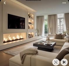 a living room filled with furniture and a flat screen tv mounted on the wall above a fire place