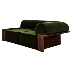 a green couch sitting on top of a wooden table