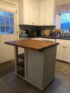 a kitchen with an island in the middle of it