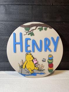 a winnie the pooh sign on a wooden wall