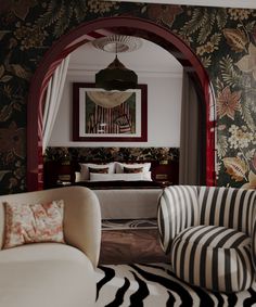 a living room filled with furniture and wallpaper