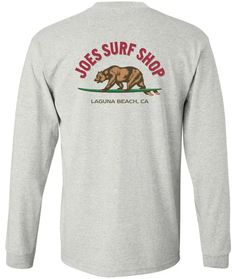 Featuring our Joe's Surf Shop brand logo, this is a must have long sleeve tee. Rep your Laguna Beach wear year round! This graphic long sleeve tee depicts everything California is! Designed in Laguna Beach, CA. Classic Heavyweight 100% Cotton Long Sleeve T-Shirt Printed in the USA Rib knit cuffs Coverseamed neck Double-needle sleeves and hem Free Shipping on US orders 65$+ Heather Grey Long Sleeve T-shirt For Streetwear, Heather Grey Long Sleeve T-shirt With Letter Print, Heather Grey Long Sleeve Graphic T-shirt, Tri-blend Long Sleeve Graphic Tee, Tri-blend Long Sleeve T-shirt With Letter Print, Tri-blend Long Sleeve Tops With Letter Print, Heather Grey Long Sleeve Tops With Logo Print, Heather Grey Long Sleeve Top With Logo Print, Laguna Hills California