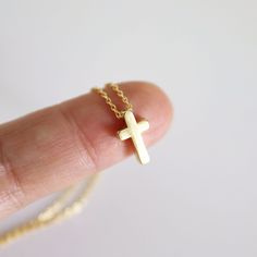 "A beautiful and lovely tiny gold necklace featuring a small & cute gold cross pendant.Lobster clasp closure. Simple and warm.  The dainty gold cross necklace is perfectly paired with any outfit or a great gift! Your beautiful necklace will ship in a gift box. If you have any questions, please feel free to contact me. Thanks :)    ♥ Chain length 14\"-18\" ♥ Cross pendant  1/4\" x 3/8\" ♥ Gold plated over brass ♥ Delivery Time Fast shipping within 1 - 3 days  + See more Rudiana Accessories + www.Rudiana.etsy.com" Simple Necklace With Delicate Chain And Cross Pendant, Dainty Yellow Gold Cross Necklace For Everyday, Delicate Cross Pendant Necklace For Gift, Delicate Cross Necklace For Gift, Simple Cross Necklace With Delicate Chain, Delicate Cross Necklace Perfect As A Gift, Minimalist Gold Cross Necklace, Minimalist Cross Charm Necklace With Delicate Chain, Gold Cross Necklace With Delicate Chain For Everyday