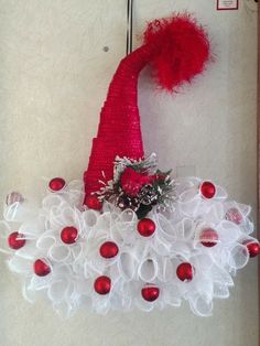 a red and white christmas wreath hanging on the wall