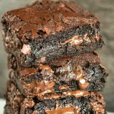 a stack of brownies with chocolate frosting on top