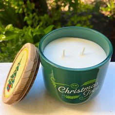 a candle sitting on top of a table next to a container