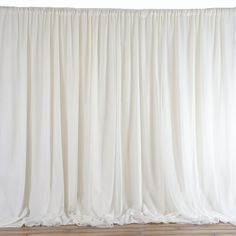 a white curtain is hanging on the wall