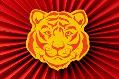 a close up of a red and yellow background with a tiger on it's face