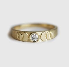 a gold ring with three diamonds on it