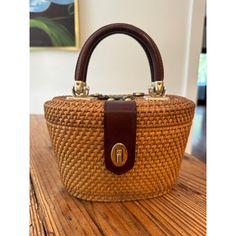 This Woven Purse Is A Must-Have For Any Fashion-Forward Woman. The Satchel/Top Handle Bag Style Is Perfect For A Day Out Or A Night On The Town. The Exterior Is Made Of Straw In A Beautiful Brown Color, While The Lining Also Features A Light Canvas Color. The Double Handles Are Made Of Leather, Adding A Touch Of Luxury To This Satchel. The Purse Is Medium-Sized And Perfect For Carrying All Your Essentials. The Pattern Is Woven, Adding A Unique Touch To The Bag. This Purse Is A Great Addition To Classic Brown Shoulder Bag With Bamboo Handle, Vintage Cognac Shoulder Bag For Shopping, Vintage Cognac Bag With Top Carry Handle, Brown Straw Bag With Gold-tone Hardware For Daily Use, Brown Straw Bag With Gold-tone Hardware For Shopping, Brown Straw Shopping Bag With Gold-tone Hardware, Vintage Natural Straw Bag, Vintage Light Brown Tote Bag, Vintage Straw Bag With Bamboo Handle