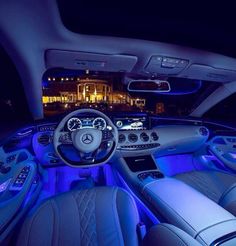 the interior of a car with blue lights