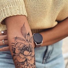 a woman with a flower tattoo on her arm