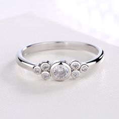 Looking for the perfect small ring to propose your love with, or give as a gift? This stunning all-white round ring from Swarovski will not let you down. Made from sterling silver, the crystal accents add a decorative touch. The simple style and highly polished finish make it easy to wear every day and make for a great item for birthdays or anniversaries. The perfect proposal ring, this delicate beauty is made from sterling silver and Swarovski crystals, giving you the look you want for your spe Simple Rings With Small Diamonds Silver, Necklaces Dainty, Perfect Proposal, Small Ring, Layering Necklaces, Popular Jewelry, Everyday Rings, Current Styles, Round Rings