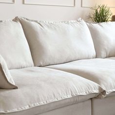 a white couch with four pillows on it