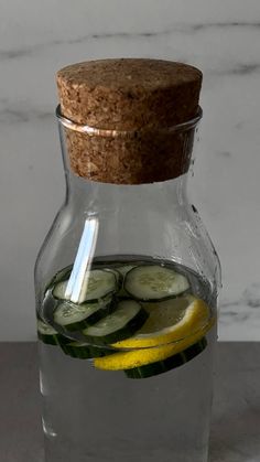 a glass pitcher filled with cucumber and lemon slices