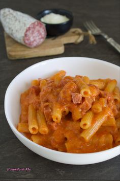 a white bowl filled with pasta and sauce