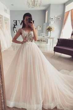 a woman taking a selfie in front of a mirror while wearing a wedding dress