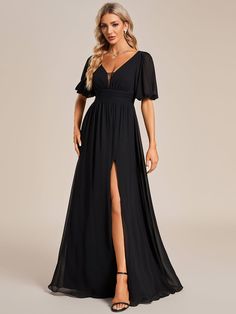 a woman wearing a long black dress with a slit down the side and a v neckline