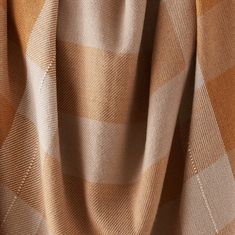 an orange and beige checkered fabric with white stitching on the bottom half of it