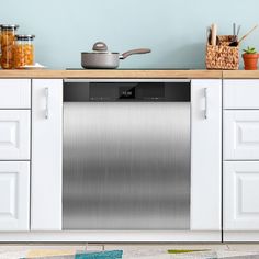 a stainless steel dishwasher in the middle of a kitchen with white cupboards