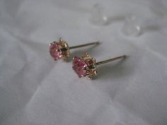 14K Pink Stone Stud Yellow Gold Earrings Vintage Karat KT Solid Pierced Post Materials: 14K solid gold metal marked (14K), (pink stones - do not know what they are made from) with plastic/silicone post backs Condition: excellent vintage Measures - 5mm x 5mm x 4mm Maker's mark - P Questions welcome. Pink 14k Gold Wedding Earrings, Pink Earrings With Prong Setting For Anniversary, Pink Prong Set Earrings For Anniversary, Pink Wedding Earrings With Birthstone, Fine Jewelry Hallmarked Pink Earrings, Pink Hallmarked Fine Jewelry Earrings, Hallmarked Pink Fine Jewelry Earrings, Pink Round Birthstone Earrings, Pink Birthstone Round Earrings