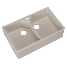 a white double bowl sink with two holes