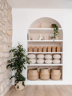 the shelves are filled with baskets and vases