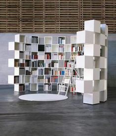 a white book shelf sitting next to a ladder in front of a bookshelf