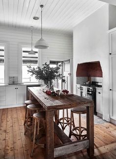 the instagram page shows an image of a kitchen with white walls and wood floors