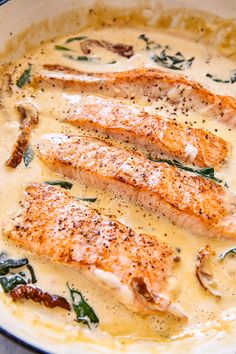 some fish is cooking in a white sauce