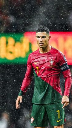 the soccer player is standing in the rain