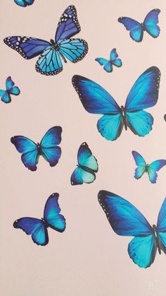 a group of blue butterflies flying in the sky