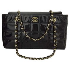 Classic Chanel Black Enamel Shoulder Bag. Leather Chicklet Design. Vintage Chanel with gold color accents. CC in the front of the bag. Leather and gold straps. The interior of the bag is leather and has separating compartments. The interior has a wonderful CC print fabric. The interior has a leather badge that has Chanel Italy Imprinted/Stamped on the leather. This bag measures approx. - 12.75w x 7h x 3.5d This bag measures approx. - 12.75w x 7h x 3.5d No box is included in this listing. Pink Chanel Flap, Vintage Chanel Bag, Chanel Boutique, Classic Chanel, Classic Flap Bag, Chanel Collection, Color Accents, Pink Chanel, Chanel Purse