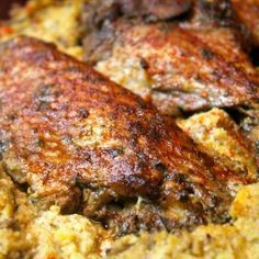 some meat is sitting on top of the food in the pan, ready to be eaten