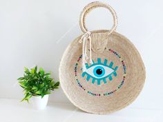 I love Mexico celebrates the native crafts of Mexico and the artists that produce them, enabling them and their communities to get recognized for their talented work and achieve economic stability for their families. This listing is for this bag shown on the pictures, hand made of palm leaf and dyed with natural vegetable dye. The evil eye symbol is commonly used as a protection. Approx measurements : 14 inches diameter, please see photos for measurements. The bag is very nicely made, strong and Handmade Artisan Beach Bag As Gift, Artisan Handmade Beach Bag As A Gift, Handmade Artisan Beach Bag For Gift, Handmade Natural Beach Bag As Gift, Artisan Handmade Straw Bag As Gift, Handmade Artisan Straw Bag As Gift, Handmade Artisan Straw Bag For Gifts, Traditional Natural Straw Bag For Vacation, Bohemian Handmade Straw Bag Gift