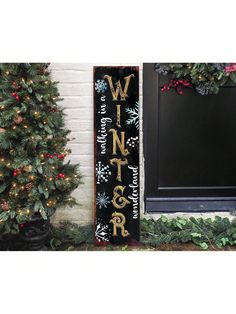 a wooden sign that says winter on it next to a christmas tree and potted plant