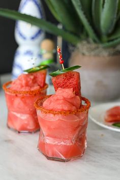 two glasses filled with watermelon and garnished with a toothpick