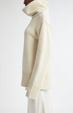 A dramatically oversized turtleneck brings scarf-inspired warmth to this roomy sweater knit from pure cashmere in a pale ivory hue. 27" length (size Large) Turtleneck Long sleeves Dropped shoulders Ribbed cuffs and hem 100% cashmere Dry clean Imported Designer Clothing Cream Winter Turtleneck With Ribbed Cuffs, Cream Turtleneck With Ribbed Cuffs For Winter, Classic Oversized Turtleneck Sweater, Classic White Turtleneck With Ribbed Cuffs, Cream Cashmere Sweater With Ribbed Cuffs, Classic White Funnel Neck Sweater, Cream Turtleneck With Ribbed Cuffs, Cozy Cream Cashmere Sweater, White Cashmere Sweater With Funnel Neck