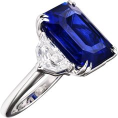 a blue and white diamond ring with an oval cut center surrounded by two claw - prongs